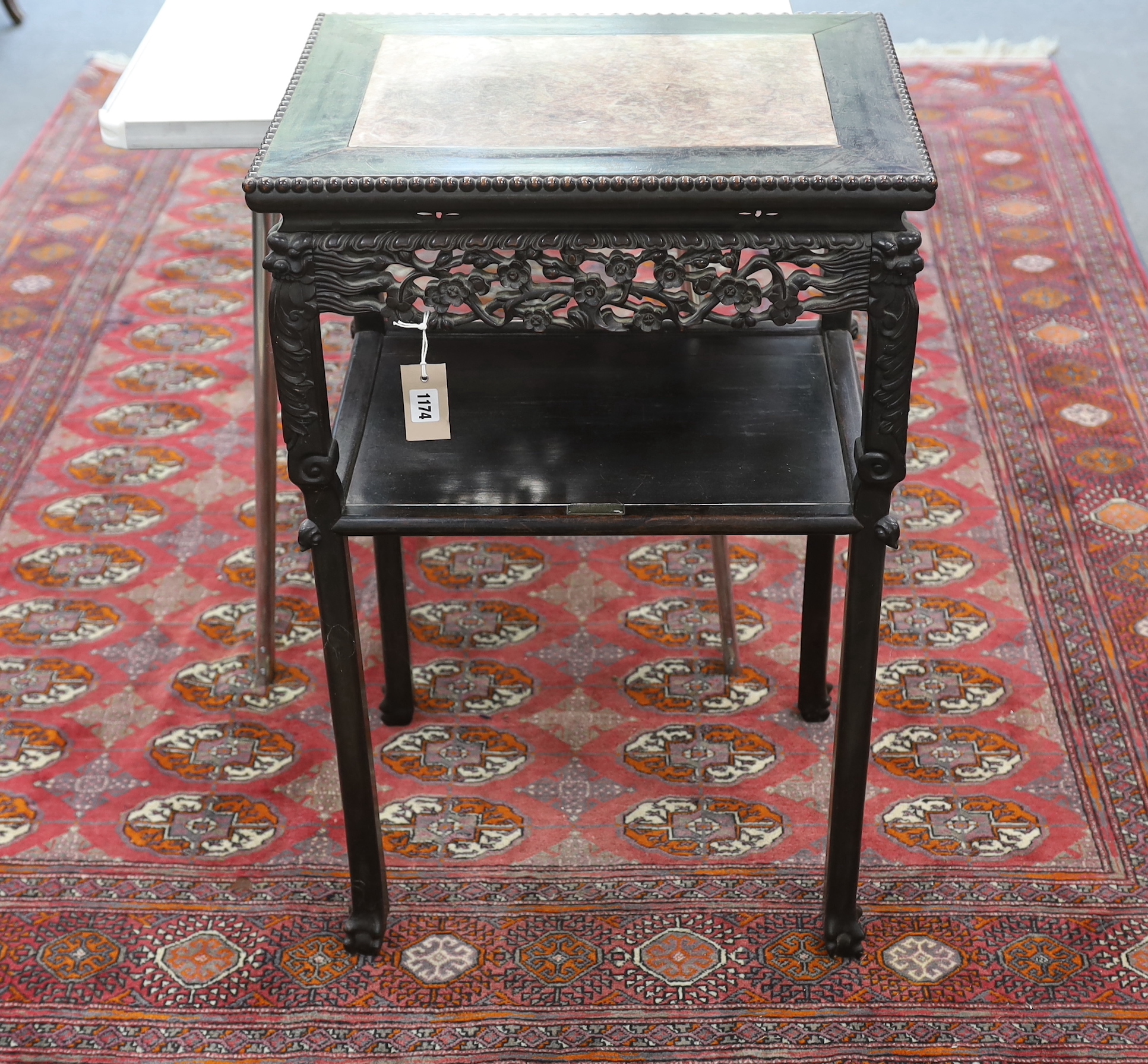 A Chinese carved hardwood marble topped rectangular two tier table, width 51cm, depth 40cm, height 80cm